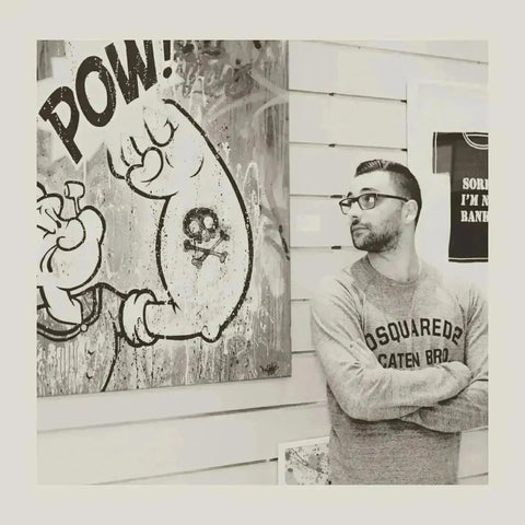 Graffiti art of cartoon character with POW next to man in glasses and sweatshirt in Mr Oreke collection.