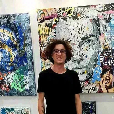 Young man with curly hair and glasses in black t-shirt from YBA collection.