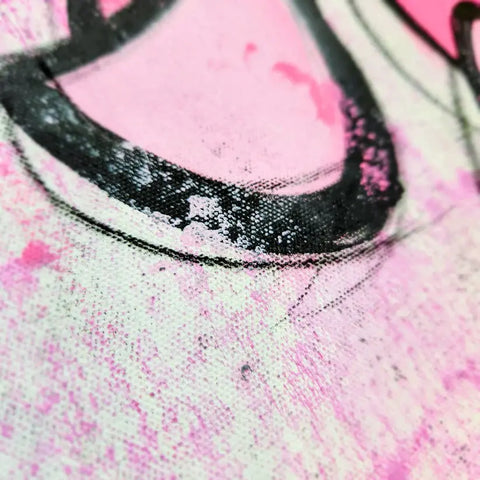 A close up of a pink and black painting