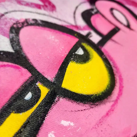 A close up of a pink and yellow painting