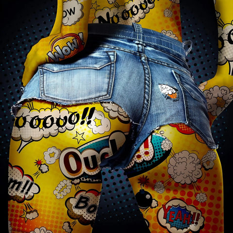 A person wearing a pair of jeans with comic comics on them