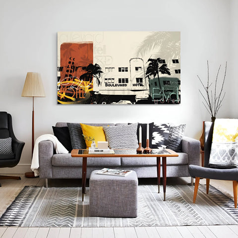 Modern living room with a gray sofa, patterned throw pillows, and a vibrant urban-themed artwork above.