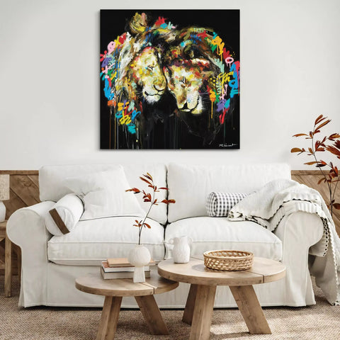 A large canvas painting of two lions on a black background