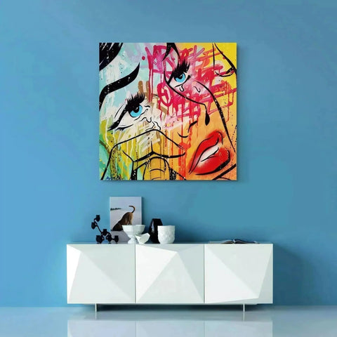 Vibrant abstract painting featuring facial features with bold colors and graffiti-style elements.