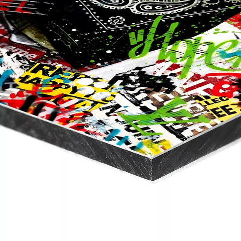 There is a skateboard with graffiti on it sitting on a table