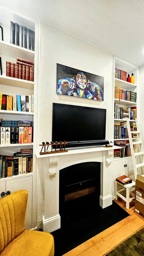 Fireplace with built-in bookshelves and a mounted TV above it.