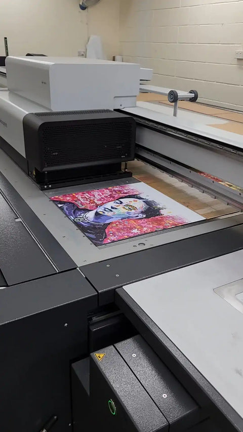 Flatbed printer or scanner with a colorful magazine cover visible on its surface.