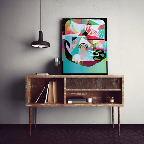 A painting on a wall above a wooden table