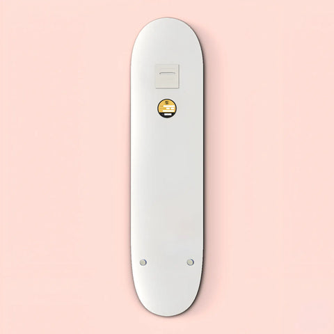 White skateboard deck with a small circular yellow logo.