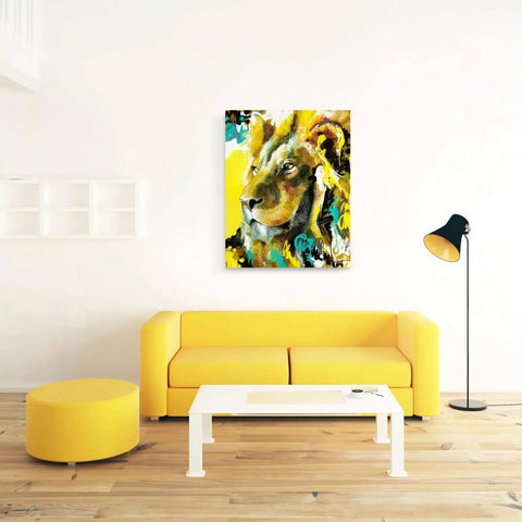 A yellow couch in a white room with a painting on the wall