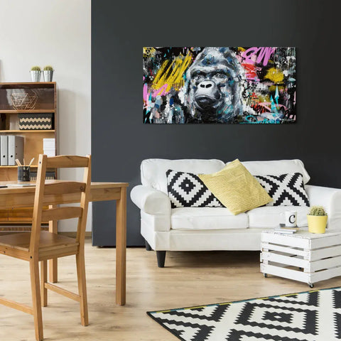 A living room with a white couch and a painting on the wall