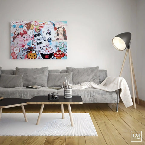 Colorful, eclectic pop art-style canvas hanging above a gray sofa.