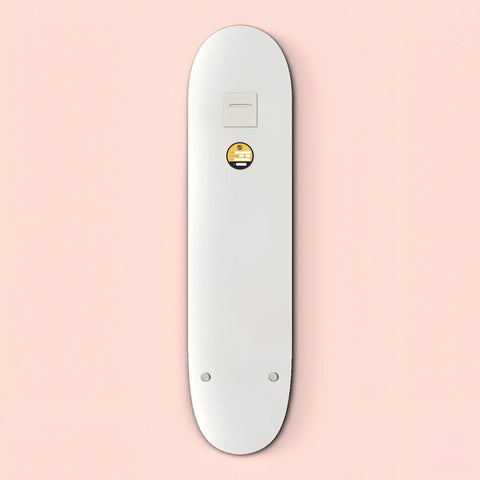 White skateboard deck with a small circular yellow logo.