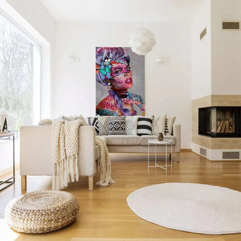 A living room with a couch, a white chair and a painting on the wall