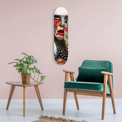 Skateboard deck with colorful graffiti-style artwork featuring a screaming face.