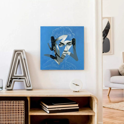 A blue and white painting of a woman’s face