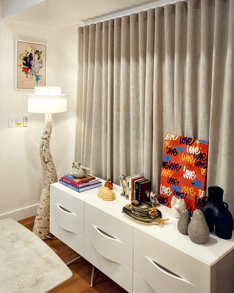 White dresser or sideboard with curved drawer handles.